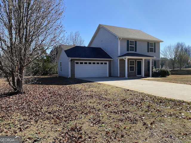 traditional home with a garage and concrete driveway