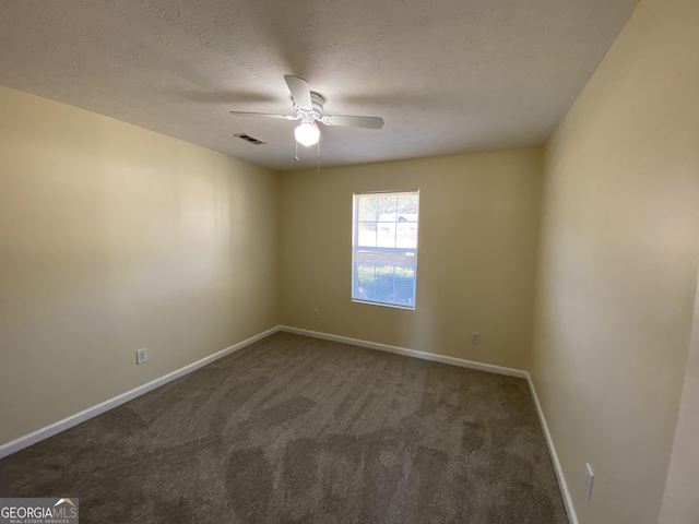 carpeted spare room with a ceiling fan, baseboards, visible vents, and a textured ceiling