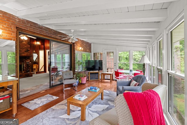 sunroom with wood finished floors and beamed ceiling