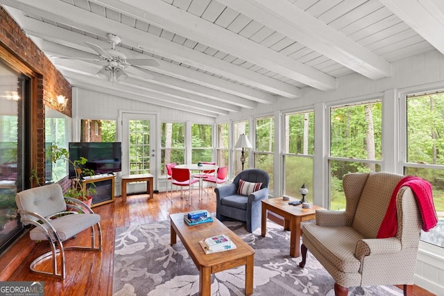 sunroom / solarium with a ceiling fan, french doors, vaulted ceiling with beams, and hardwood / wood-style floors