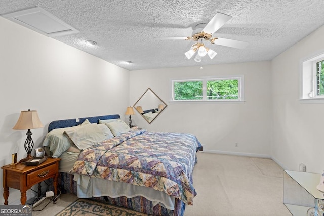 carpeted bedroom featuring a textured ceiling, ceiling fan, and multiple windows