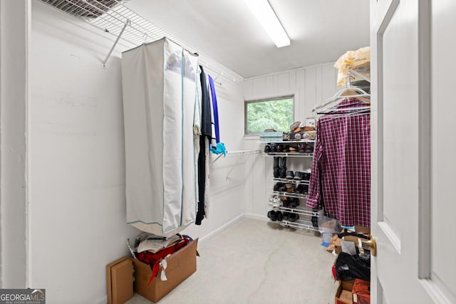 walk in closet with carpet flooring