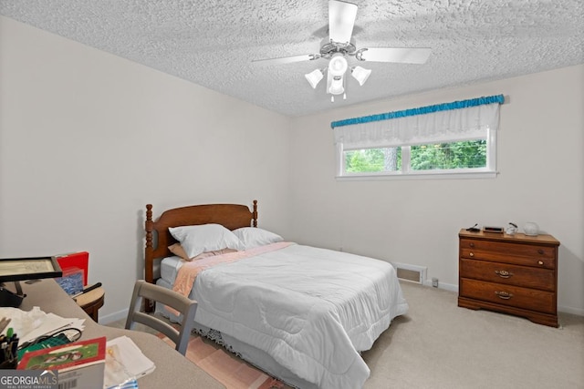 bedroom with visible vents, carpet flooring, a textured ceiling, and a ceiling fan
