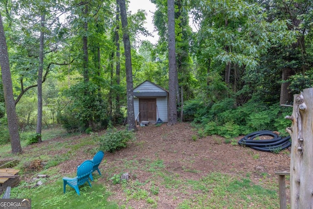 view of yard featuring an outbuilding and a shed