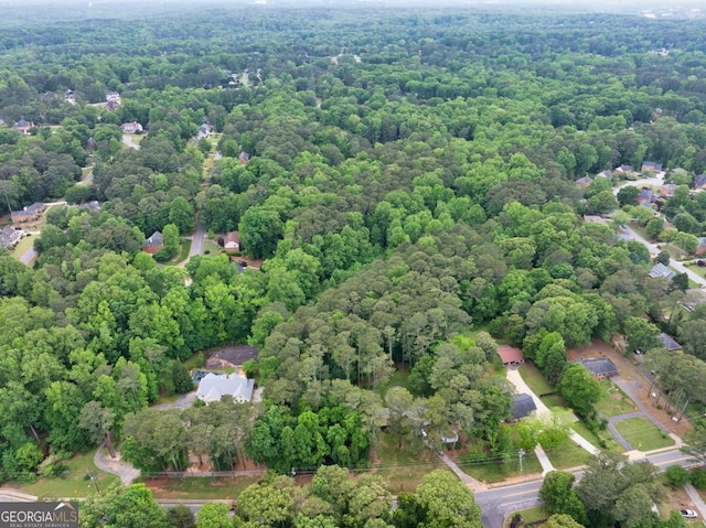 birds eye view of property featuring a forest view