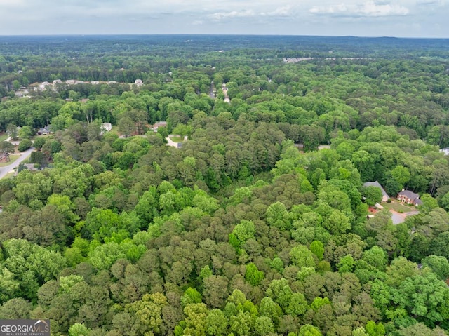 drone / aerial view featuring a wooded view