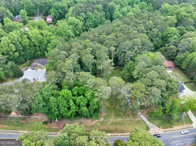 drone / aerial view featuring a view of trees
