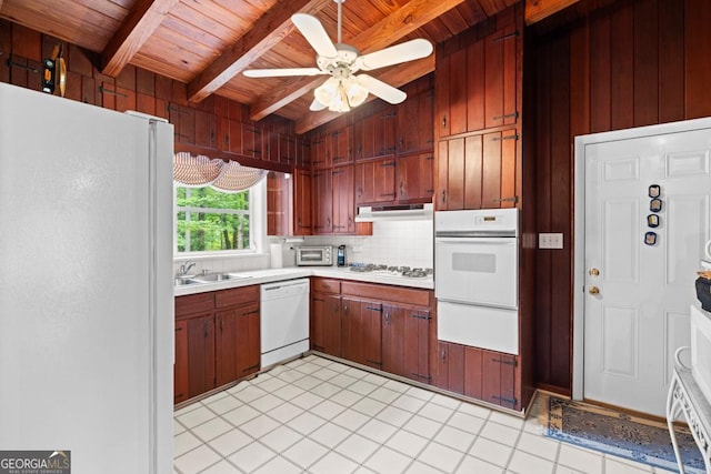 kitchen featuring beam ceiling, a warming drawer, white appliances, and wooden ceiling