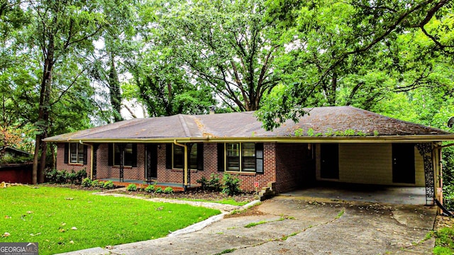 single story home featuring covered porch, driveway, a front yard, a carport, and brick siding