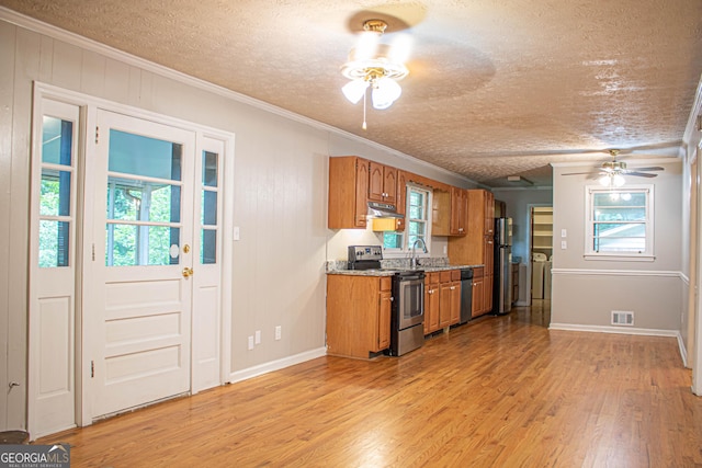 6470 Sherwood Trl, Austell, GA 30168 - kitchen featuring stainless steel appliances, ceiling fan, brown cabinets, a textured ceiling, and light wood-type flooring