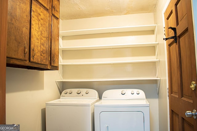 laundry room with cabinet space and washer and clothes dryer