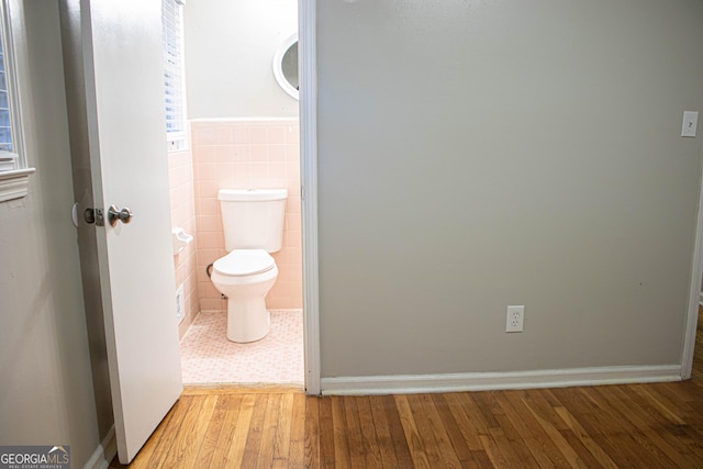 6470 Sherwood Trl, Austell, GA 30168 - bathroom featuring tile walls, wood finished floors, and wainscoting