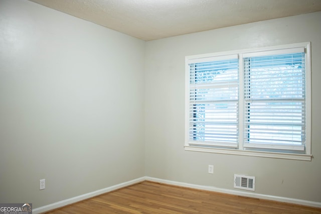 6470 Sherwood Trl, Austell, GA 30168 - spare room with wood finished floors and a textured ceiling
