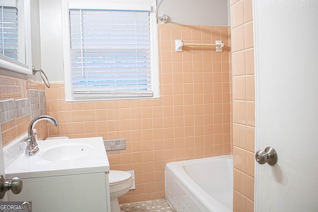 full bathroom with toilet, tile walls, and vanity