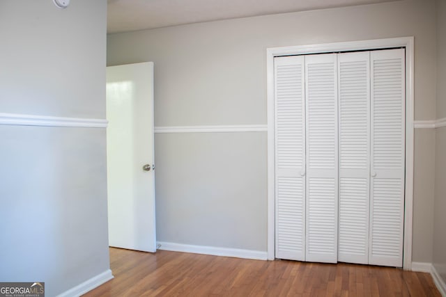 6470 Sherwood Trl, Austell, GA 30168 - unfurnished bedroom with wood finished floors and a closet