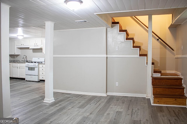 stairway with visible vents, wooden ceiling, and wood finished floors