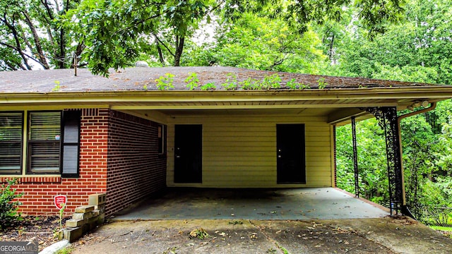 exterior space featuring brick siding and driveway