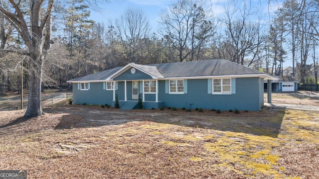 ranch-style home with fence