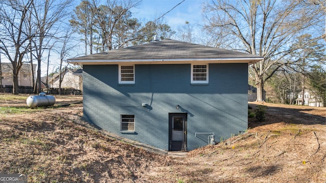 back of house with brick siding