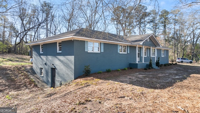 view of side of property featuring brick siding