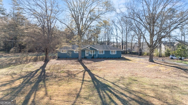 single story home featuring fence