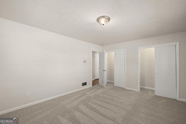 unfurnished bedroom featuring baseboards and carpet