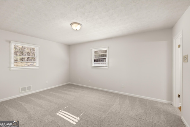 unfurnished room featuring baseboards, carpet flooring, and visible vents