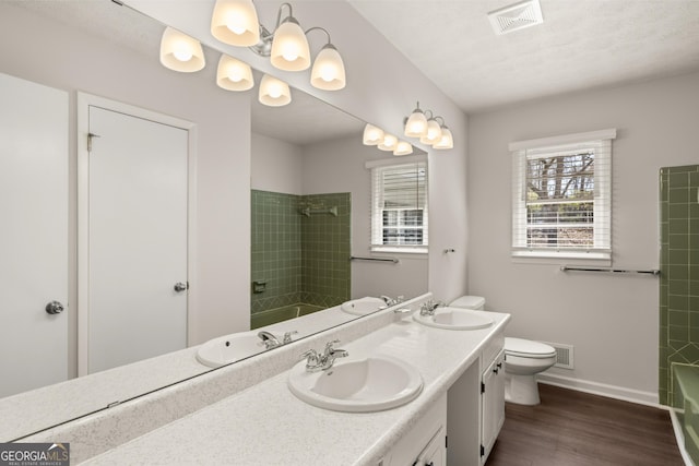 bathroom featuring a sink, bathing tub / shower combination, and visible vents
