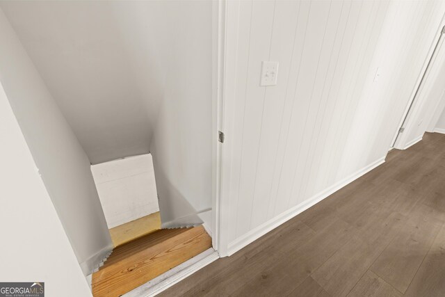 hallway with baseboards and wood finished floors