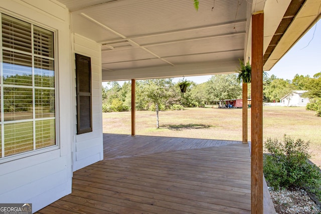 wooden terrace with a lawn