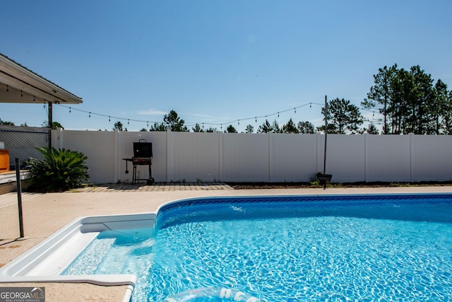 view of swimming pool with a fenced in pool and fence