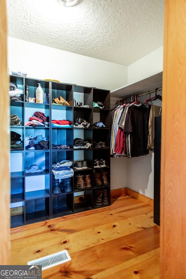 spacious closet with wood finished floors