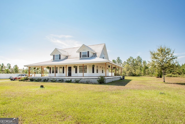 farmhouse inspired home with covered porch, metal roof, and a front yard