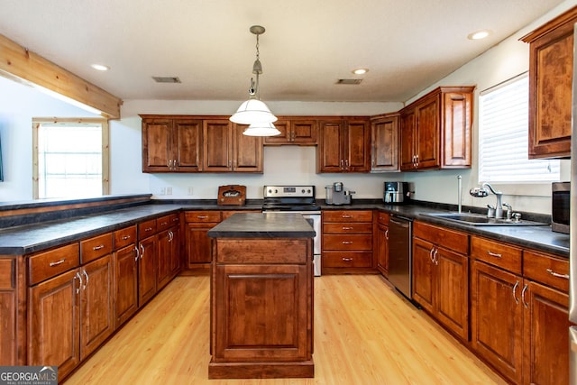 kitchen featuring a kitchen island, stainless steel appliances, light wood-type flooring, and a wealth of natural light