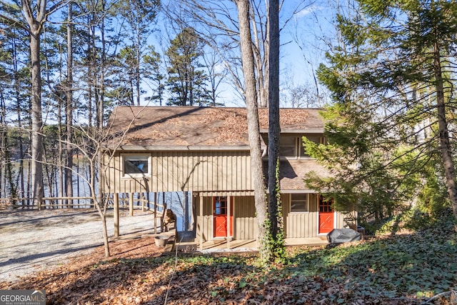 rustic home with board and batten siding and a shingled roof