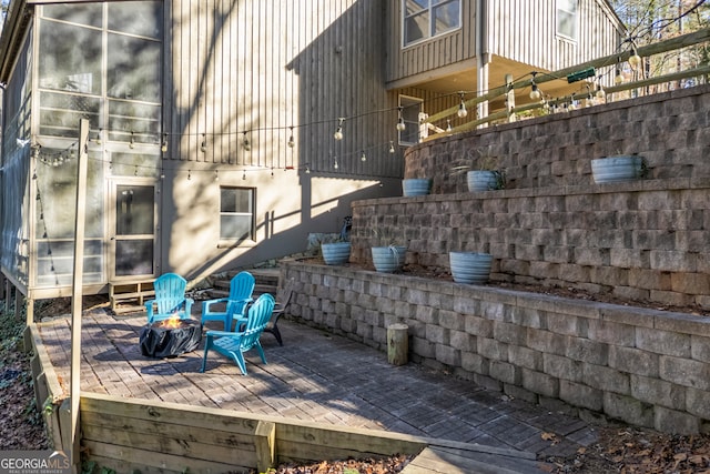 exterior space featuring a fire pit and a wooden deck