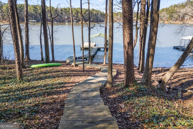 dock area with boat lift and a water view