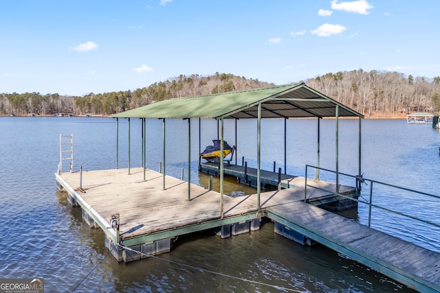 dock area with a view of trees and a water view