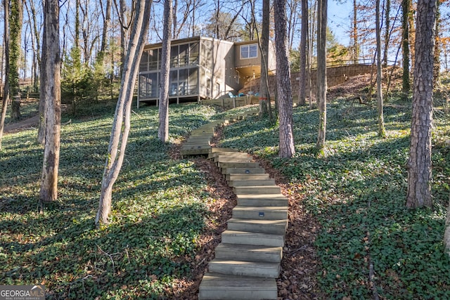 view of yard featuring stairs and a sunroom