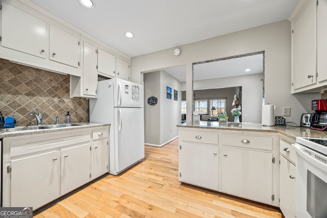kitchen with recessed lighting, a sink, backsplash, and white appliances