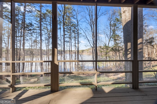 unfurnished sunroom with a water view