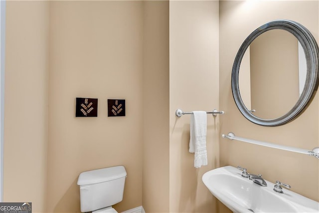half bath with a sink and toilet