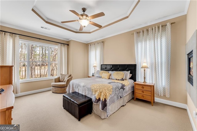 bedroom with visible vents, carpet flooring, baseboards, and a tray ceiling