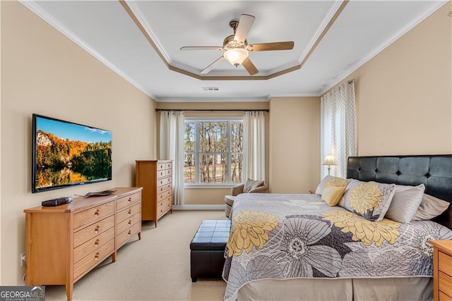 bedroom featuring ceiling fan, light colored carpet, a tray ceiling, visible vents, and ornamental molding
