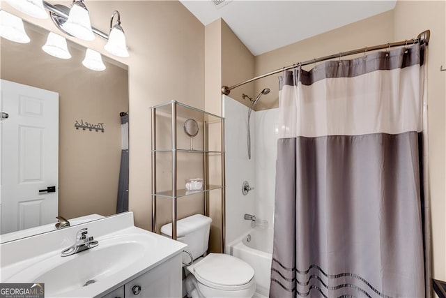 bathroom with vanity, shower / bath combo with shower curtain, and toilet