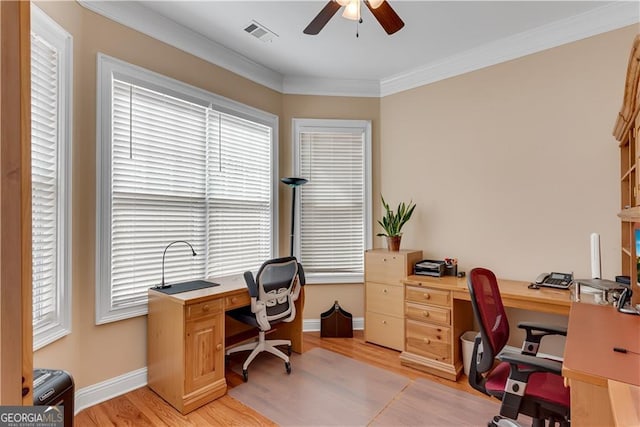 office space featuring light wood-style floors, a wealth of natural light, ceiling fan, and visible vents