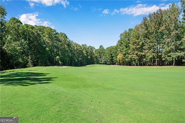 view of home's community with a lawn and golf course view