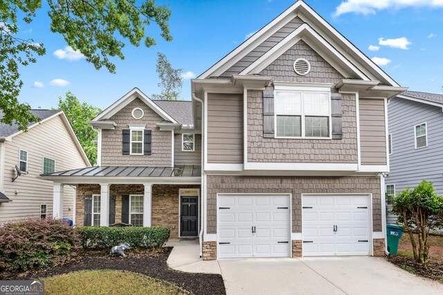 449 Highlands Loop, Woodstock, GA 30188 - view of front of house featuring concrete driveway, an attached garage, a standing seam roof, and stone siding