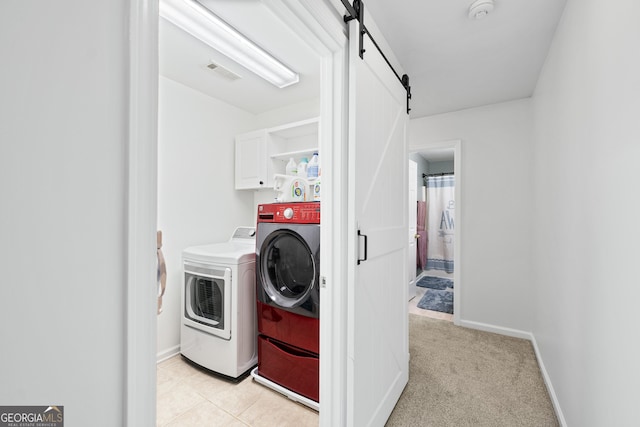 449 Highlands Loop, Woodstock, GA 30188 - laundry room featuring cabinet space, washing machine and clothes dryer, a barn door, light colored carpet, and baseboards