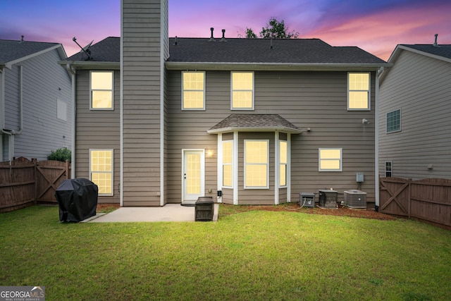 449 Highlands Loop, Woodstock, GA 30188 - back of property at dusk featuring a patio area and a chimney